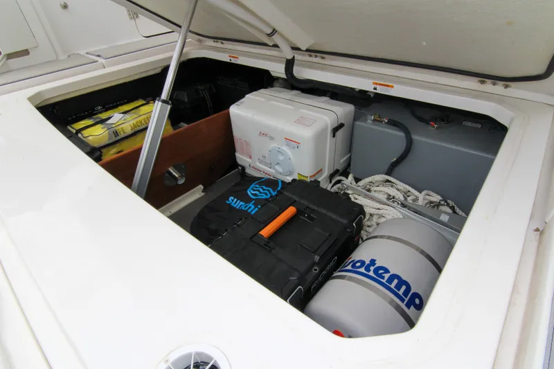  Yacht Photos Pics Open storage compartment of 2023 Regal 38 SAV boat with equipment and supplies.