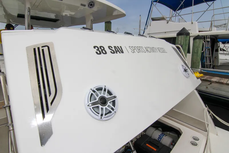  Yacht Photos Pics 2023 Regal 38 SAV Sports Activity Vessel at dockside, showcasing sleek design.