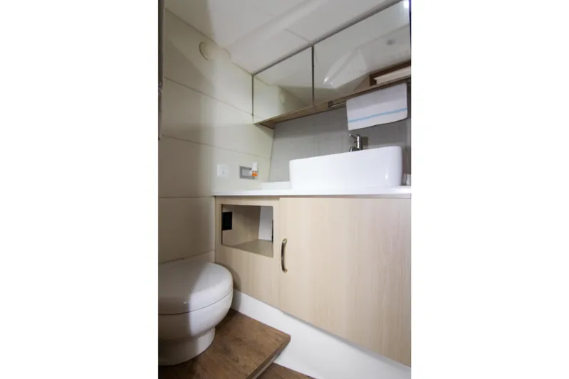 Yacht Photos Pics 2023 Regal 38 SAV yacht bathroom with modern sink and wooden cabinetry.