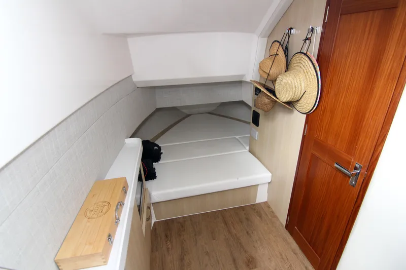  Yacht Photos Pics 2023 Regal 38 SAV cabin interior with wooden flooring and wall hooks.