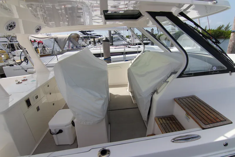  Yacht Photos Pics 2023 Regal 38 SAV boat interior with covered seats and wooden steps.