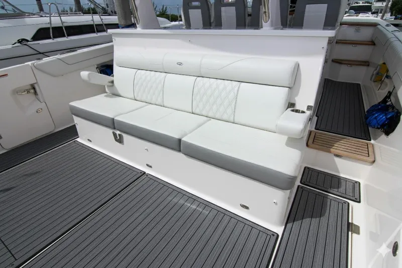  Yacht Photos Pics 2023 Regal 38 SAV boat interior with white cushioned seating and sleek flooring.