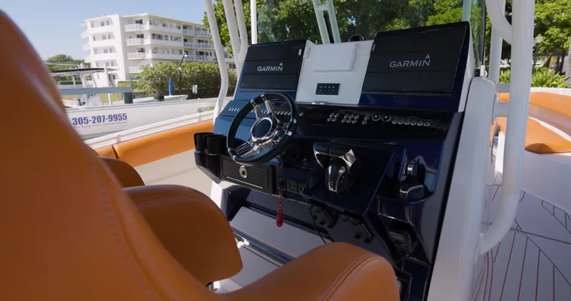  Yacht Photos Pics 2009 Hydra-Sports 4200 SF boat cockpit with Garmin navigation, orange seats, and modern controls.