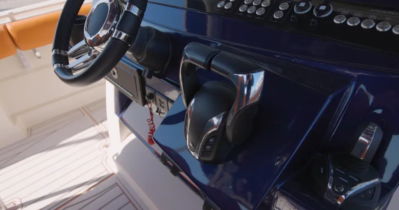  Yacht Photos Pics Control panel of a 2009 Hydra-Sports 4200 SF boat with steering wheel and throttle.