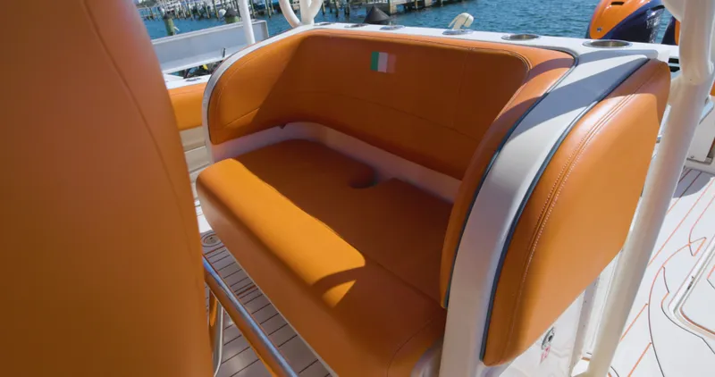  Yacht Photos Pics Orange seating on a 2009 Hydra-Sports 4200 SF boat, docked by the water.