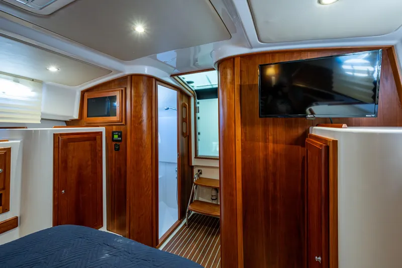  Yacht Photos Pics Luxurious interior of 2020 Back Cove 340 yacht with wood paneling and mounted TV.