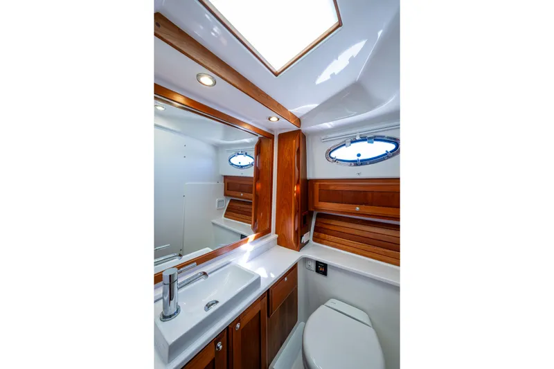  Yacht Photos Pics Luxurious bathroom in 2020 Back Cove 340 yacht with wood accents and modern fixtures.