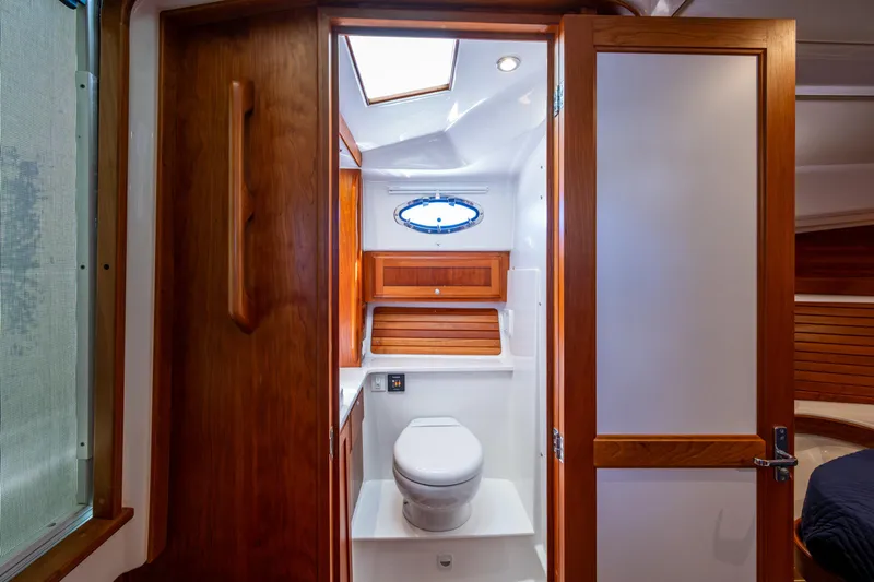 Yacht Photos Pics 2020 Back Cove 340 yacht bathroom with wooden accents and modern fixtures.