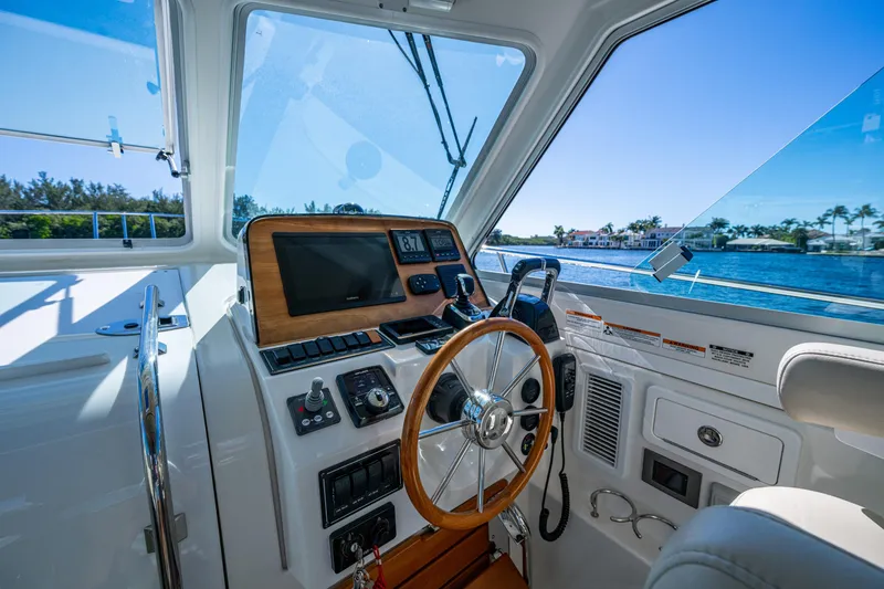  Yacht Photos Pics 2020 Back Cove 340 helm with modern controls and scenic waterfront view.