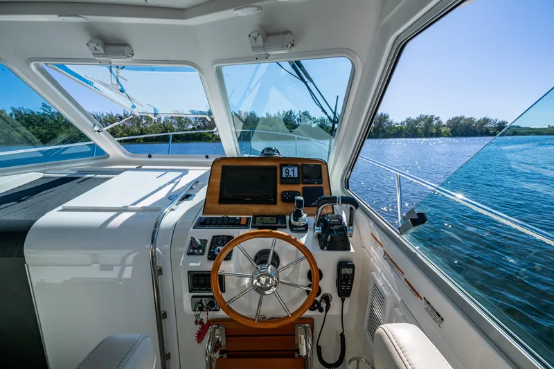  Yacht Photos Pics Interior view of 2020 Back Cove 340 boat cockpit with steering wheel and navigation equipment.