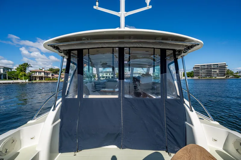  Yacht Photos Pics 2020 Back Cove 340 boat on water, featuring enclosed cabin and scenic waterfront view.