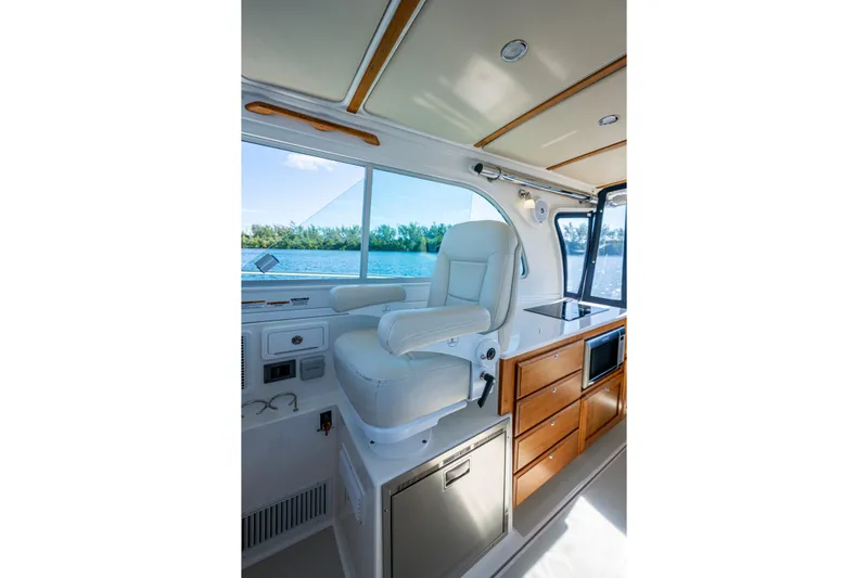  Yacht Photos Pics Interior of 2020 Back Cove 340 boat with helm seat and cabinetry.