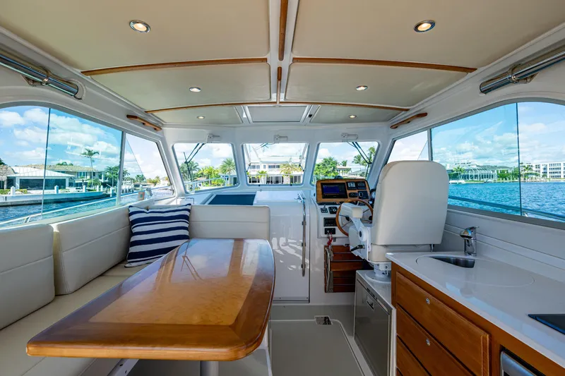  Yacht Photos Pics Interior of 2020 Back Cove 340 yacht with elegant seating and helm, overlooking waterfront.