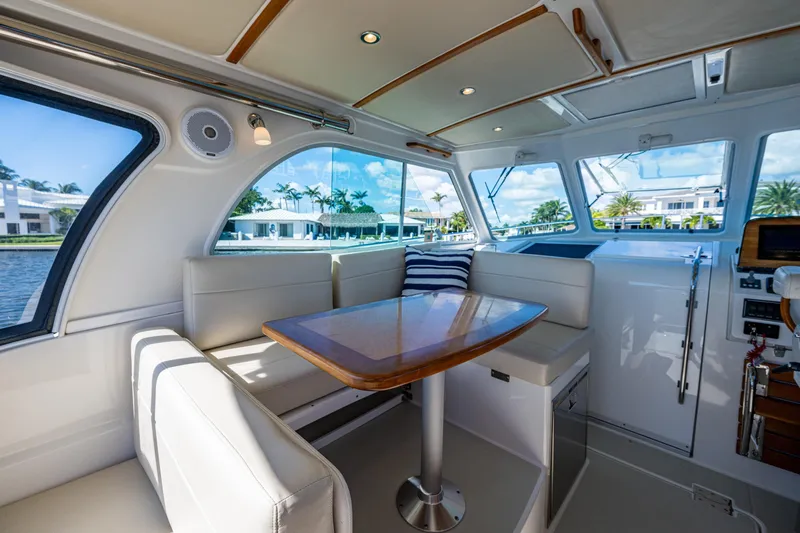  Yacht Photos Pics Interior of 2020 Back Cove 340 yacht with elegant seating and table, overlooking waterfront homes.
