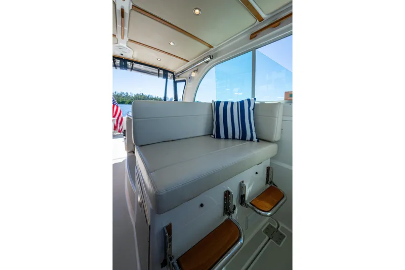  Yacht Photos Pics Interior of 2020 Back Cove 340 boat with cushioned seating and striped pillow.