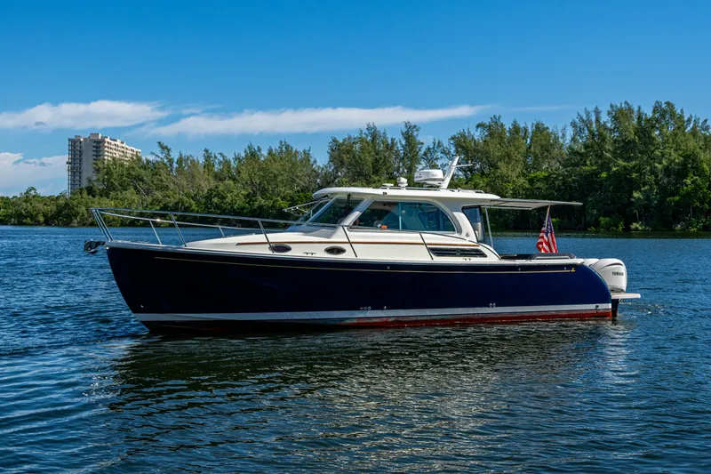  Yacht Photos Pics 2020 Back Cove 340 boat on calm water with scenic background.