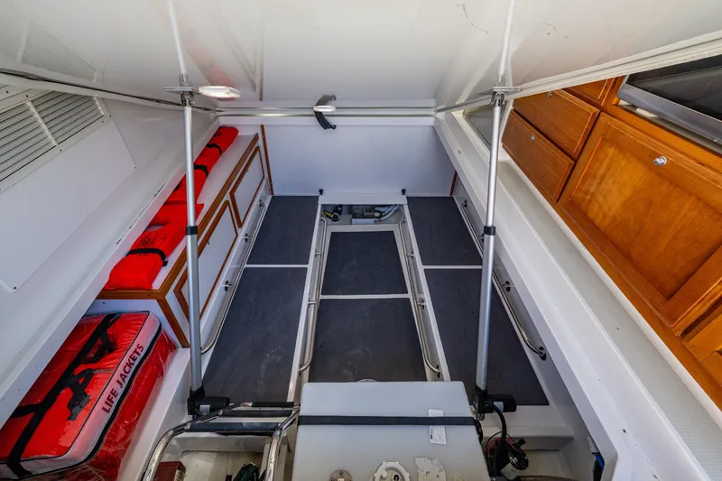  Yacht Photos Pics 2020 Back Cove 340 interior storage with life jackets and wooden cabinets.