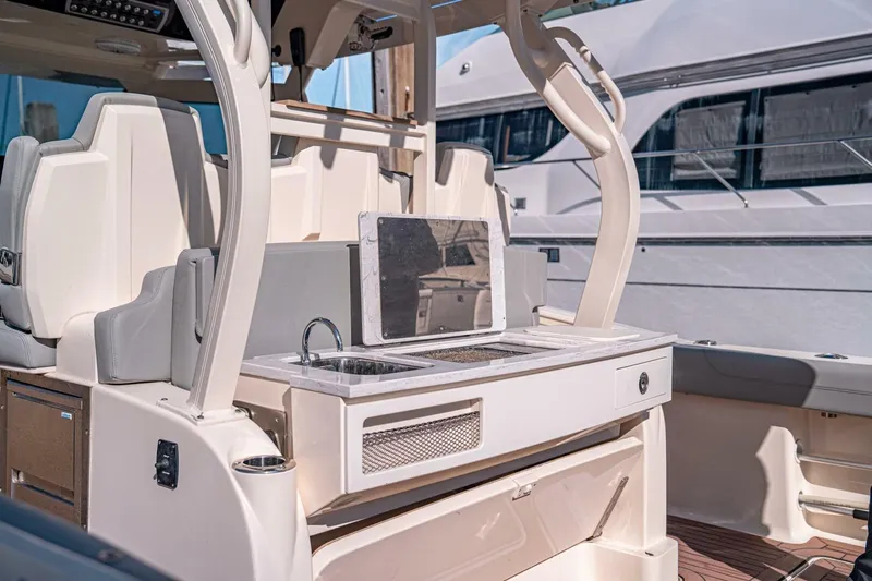 O-sea-d Yacht Photos Pics 2020 Scout 380 LXF boat interior with sink and seating area.