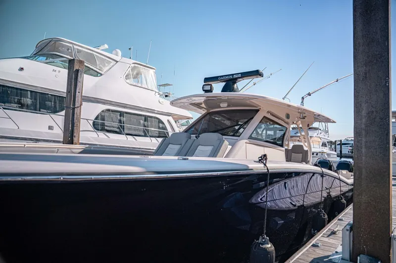O-sea-d Yacht Photos Pics 2020 Scout 380 LXF luxury boat docked at marina under clear blue sky.