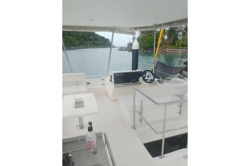  Yacht Photos Pics Leopard 43 Powercat helm station with scenic water view and lush greenery.