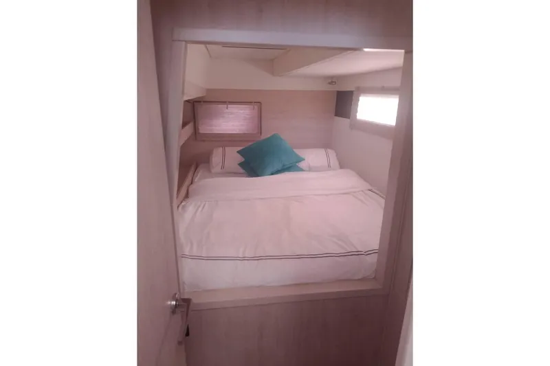  Yacht Photos Pics Cozy bedroom interior on Leopard 43 Powercat with white bedding and teal pillow.