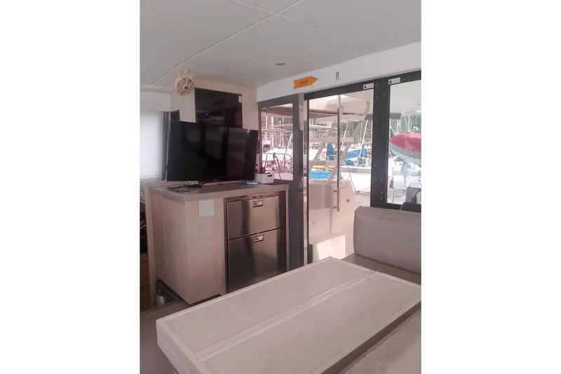  Yacht Photos Pics Interior of Leopard 43 Powercat with TV, fridge, and outdoor view.