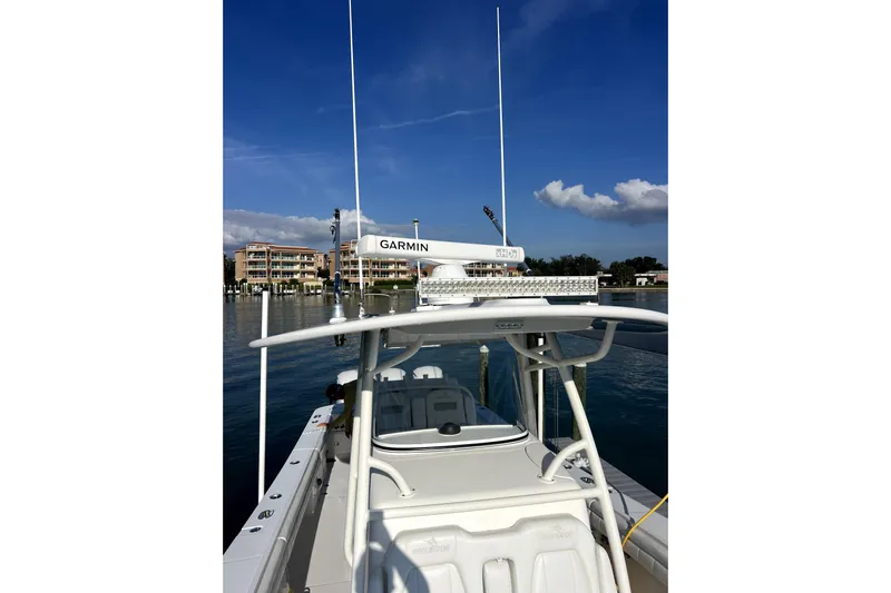  Yacht Photos Pics 2018 Regulator 34 Center Console boat with Garmin equipment, docked near waterfront buildings.