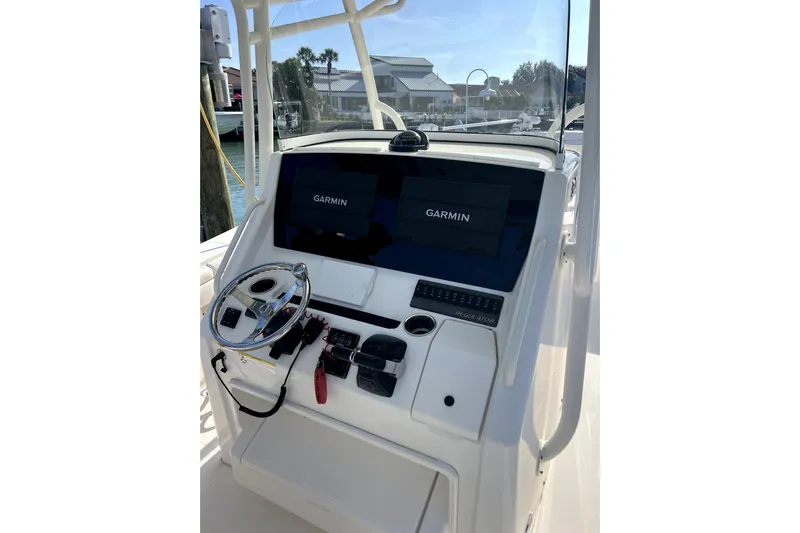  Yacht Photos Pics 2018 Regulator 34 Center Console helm with Garmin displays and steering wheel.