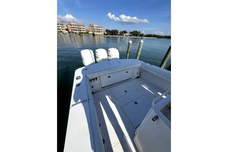  Yacht Photos Pics 2018 Regulator 34 Center Console boat docked by calm waters.