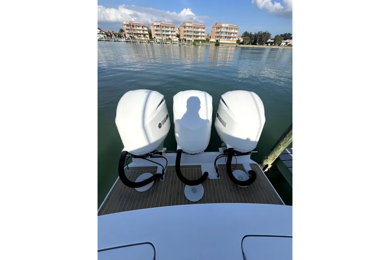  Yacht Photos Pics 2018 Regulator 34 Center Console with triple Yamaha outboard engines on calm water.