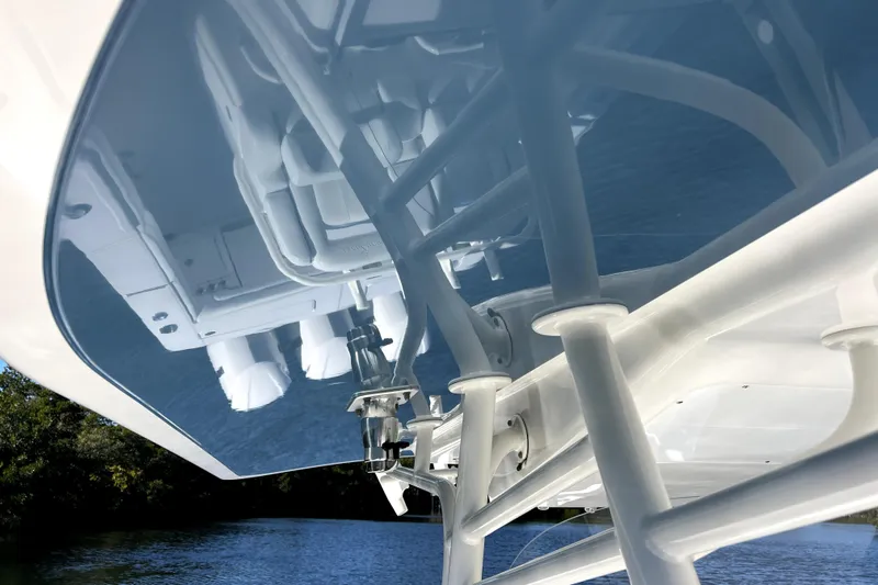  Yacht Photos Pics 2018 Regulator 34 Center Console boat reflecting on water, showcasing sleek design and structure.