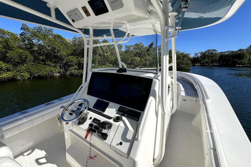  Yacht Photos Pics 2018 Regulator 34 Center Console boat on calm water, featuring advanced navigation equipment.
