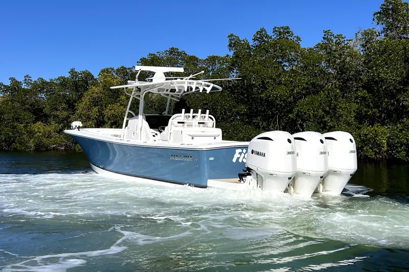  Yacht Photos Pics 2018 Regulator 34 Center Console boat with Yamaha engines cruising in a scenic waterway.