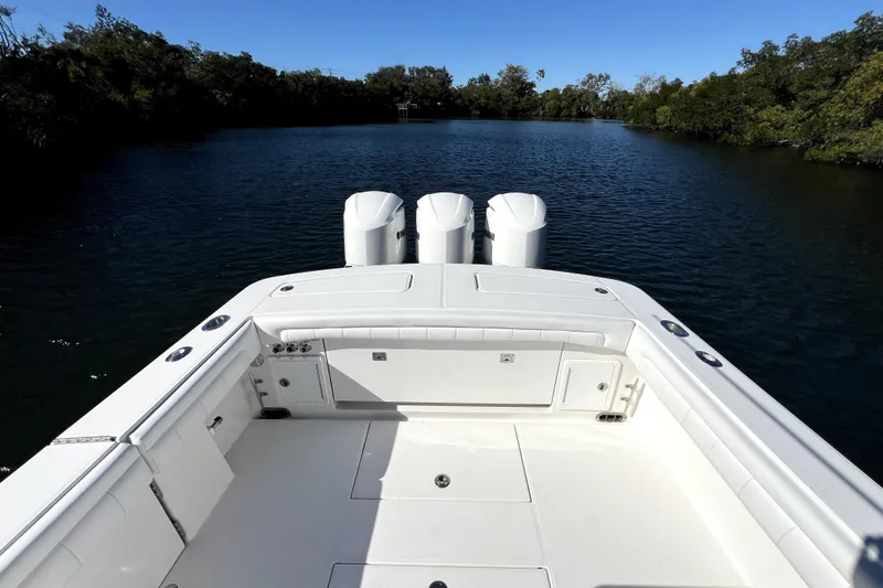  Yacht Photos Pics 2018 Regulator 34 Center Console boat on calm water, featuring triple outboard engines.