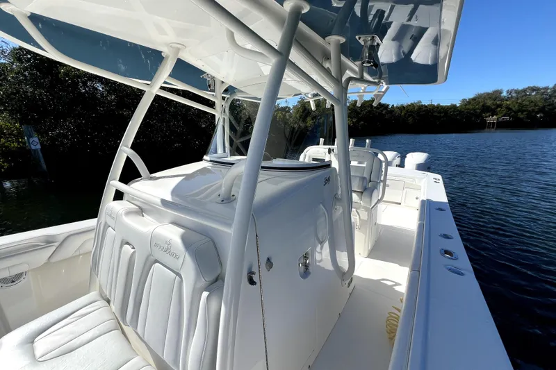  Yacht Photos Pics 2018 Regulator 34 Center Console boat on calm water, featuring sleek white design.