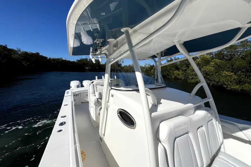  Yacht Photos Pics 2018 Regulator 34 Center Console boat cruising on a scenic waterway.