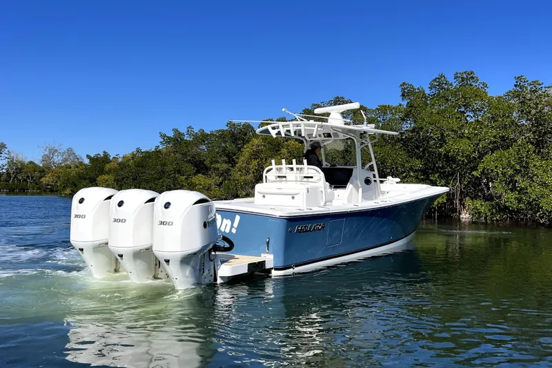  Yacht Photos Pics 2018 Regulator 34 Center Console boat with triple 300 engines on calm water.