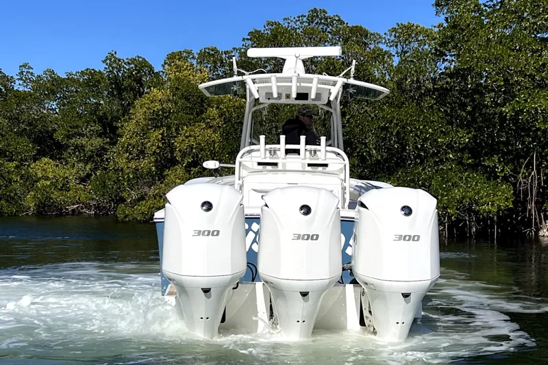  Yacht Photos Pics 2018 Regulator 34 Center Console boat with triple 300 horsepower engines in a scenic waterway.