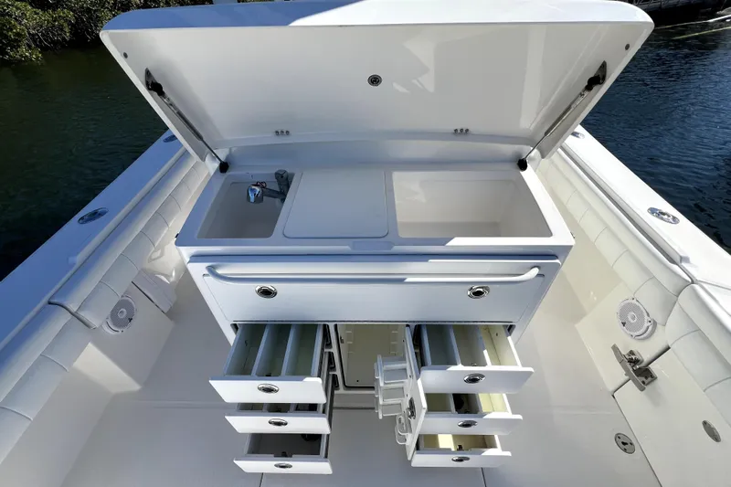  Yacht Photos Pics 2018 Regulator 34 Center Console boat with open storage compartments and sink.