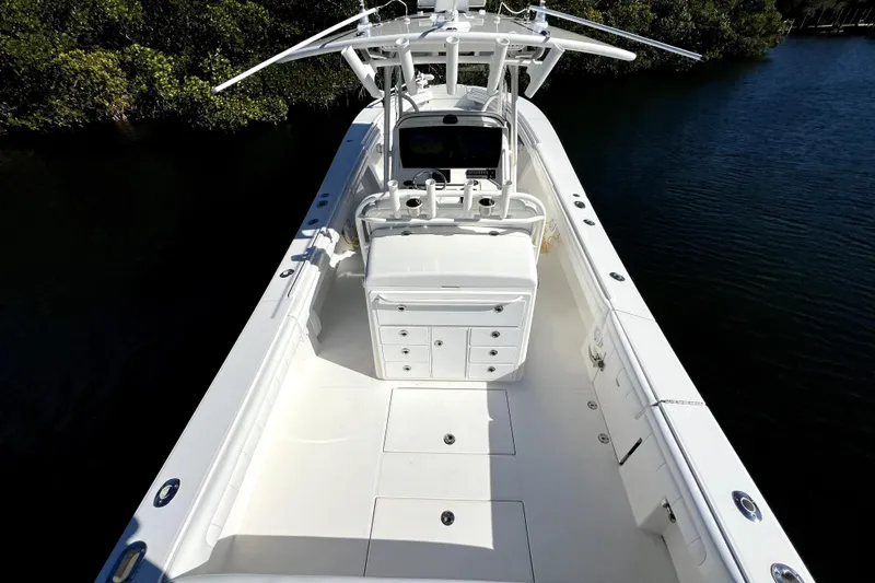 Yacht Photos Pics 2018 Regulator 34 Center Console boat on calm water, showcasing spacious deck and helm.