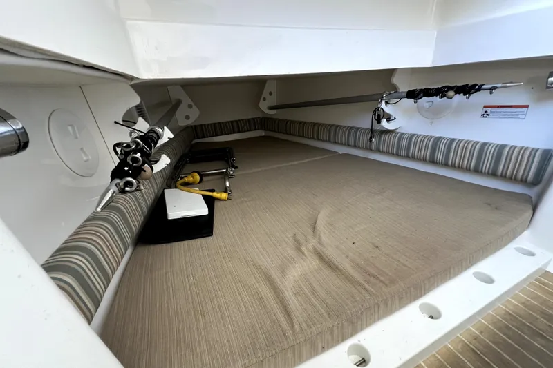  Yacht Photos Pics 2018 Regulator 34 Center Console cabin interior with fishing rods and striped cushions.