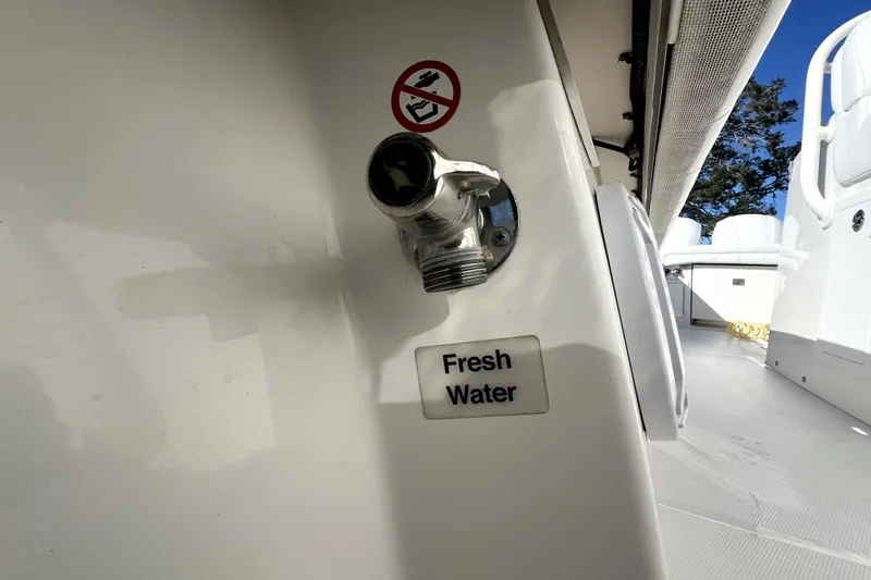  Yacht Photos Pics 2018 Regulator 34 Center Console boat with fresh water outlet and no smoking sign.