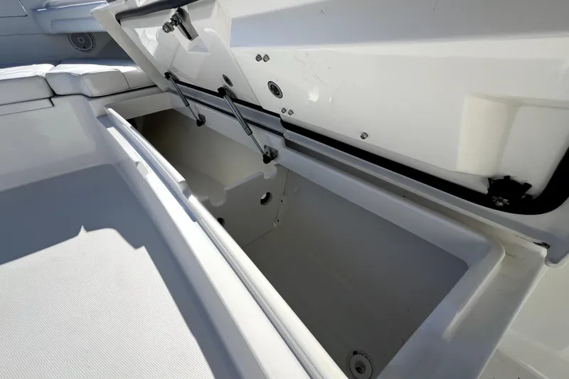  Yacht Photos Pics 2018 Regulator 34 Center Console storage compartment open, showcasing interior space.