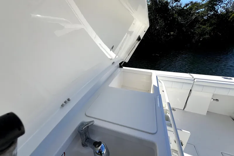  Yacht Photos Pics 2018 Regulator 34 Center Console boat with open storage compartment and sink.