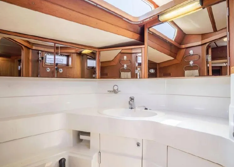 Hasard III Yacht Photos Pics 1986 Baltic 48 DP yacht bathroom with white sink and wooden accents