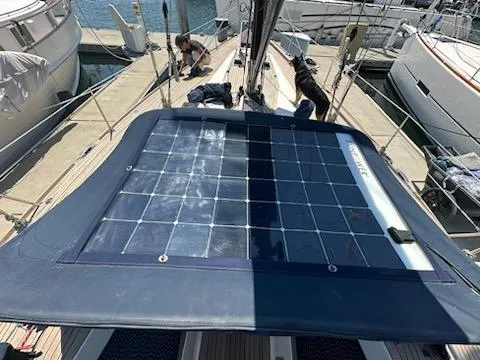 Hasard III Yacht Photos Pics Baltic 48 DP 1986 sailboat with solar panels docked at marina.