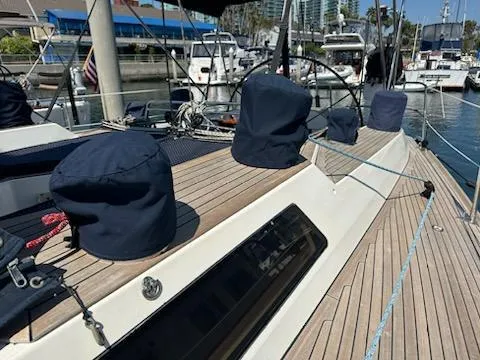 Hasard III Yacht Photos Pics Baltic 48 DP 1986 sailboat docked at marina, showcasing teak deck and covered winches.