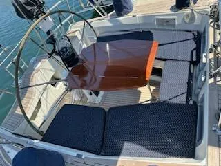 Hasard III Yacht Photos Pics Cockpit of 1986 Baltic 48 DP sailboat with wooden table and cushioned seating.