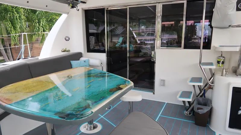  Yacht Photos Pics Luxurious 2011 Leopard 46 yacht interior with stylish seating and unique ocean-themed table.