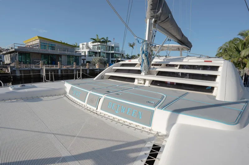  Yacht Photos Pics 2011 Leopard 46 catamaran docked near modern waterfront homes.